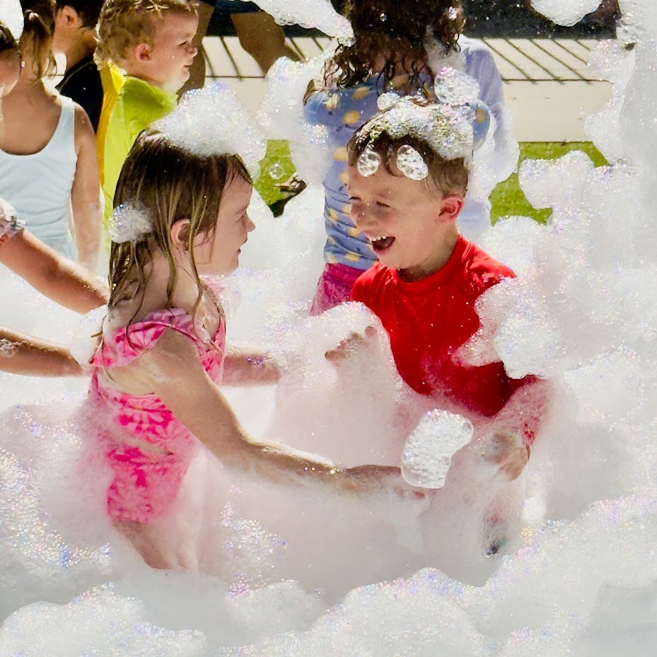 Foam party guests playing outdoors